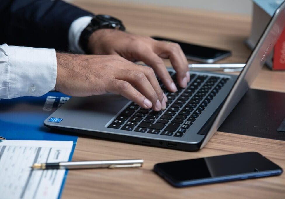 A person typing on a laptop computer.